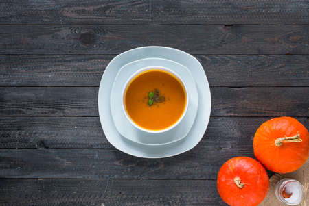 Homemade Pumpkin Soup on rustic wooden background, free space for text. Top viewの写真素材