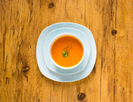 Homemade Pumpkin Soup on rustic wooden background, free space for text. Top viewの写真素材