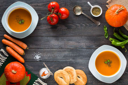 Homemade Pumpkin Soup on rustic wooden background, free space for text. Top viewの写真素材