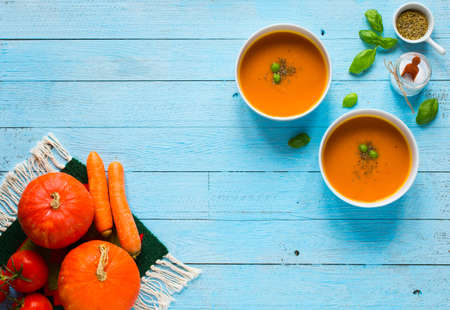 Homemade Pumpkin Soup on rustic wooden background, free space for text. Top viewの写真素材