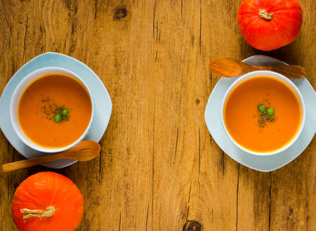 Homemade Pumpkin Soup on rustic wooden background, free space for text. Top viewの写真素材