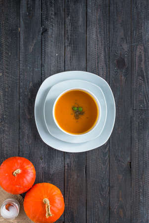 Homemade Pumpkin Soup on rustic wooden background, free space for text. Top viewの写真素材