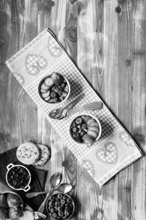 Cereal. Breakfast with muesli, and fresh fruits in bowls on a rustic wooden background, free space for textの写真素材