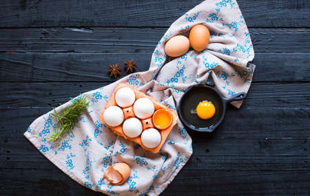 Chicken egg on a dark wooden background, free space for text. Top viewの写真素材