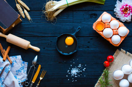 Chicken egg on a dark wooden background, free space for text. Top viewの写真素材