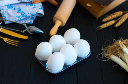 Chicken egg on a dark wooden background, free space for text. Top viewの写真素材