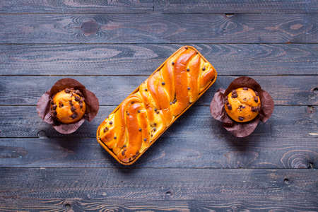 Breakfast with different pastries and fruits on a wooden table free space for textの写真素材