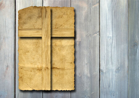 Old vintage Christian paper cross over wood wall backgroundの写真素材