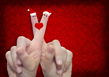 Conceptual Christmas fingers in love on vintage old red backgroundの写真素材