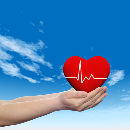 3D conceptual heart with pulse held in hands for health designsの写真素材