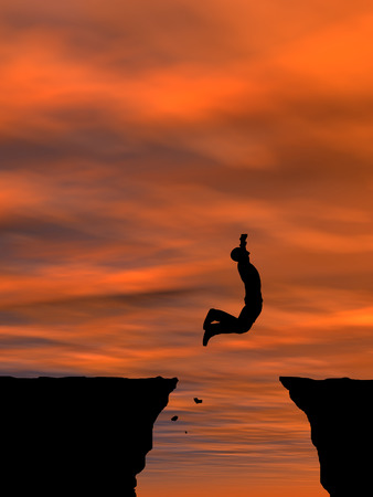 Concept or conceptual business man silhouette jumping at sunset sky backgroundの写真素材