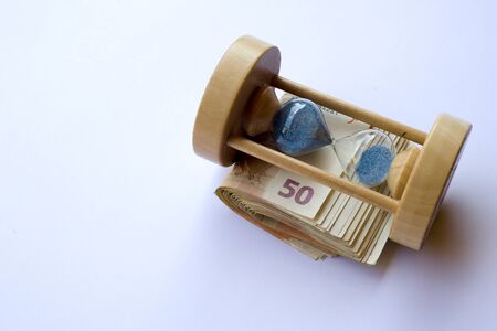 Concept or conceptual euro paper money banknote with a sand glass or time backgroundの写真素材