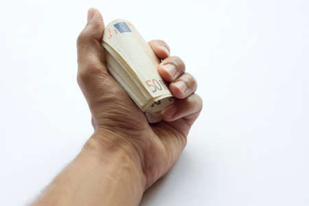 Concept or conceptual euro paper money banknote in human or man hands isolated on white backgroundの写真素材
