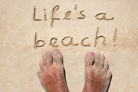 Conceptual life is a beach text in sand and water wave backgroundの写真素材