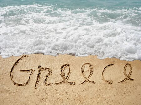 Conceptual Greece text in sand and water wave backgroundの写真素材