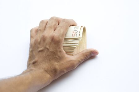 Concept or conceptual euro paper money banknote in human or man hands isolated on white backgroundの写真素材