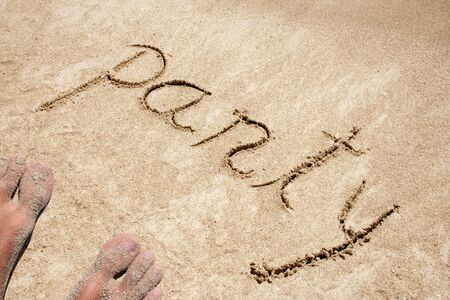 Concept or conceptual party text handwritten in sandの写真素材