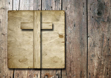 Old vintage Christian paper cross over wood wall backgroundの写真素材