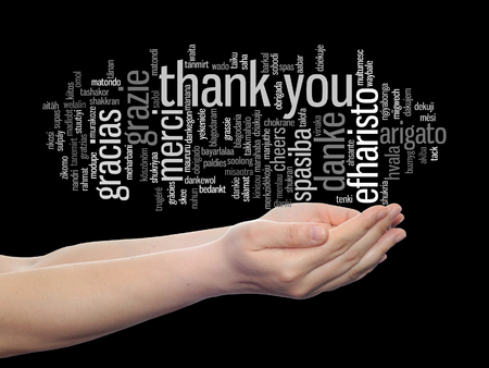 Conceptual thank you multilingual word cloud in hands isolated on backgroundの写真素材