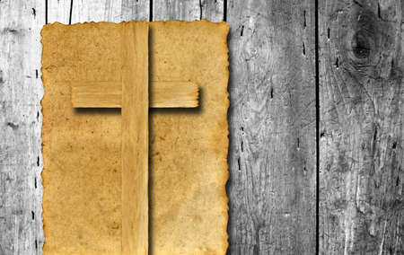 Old vintage Christian paper cross over wood wall backgroundの写真素材
