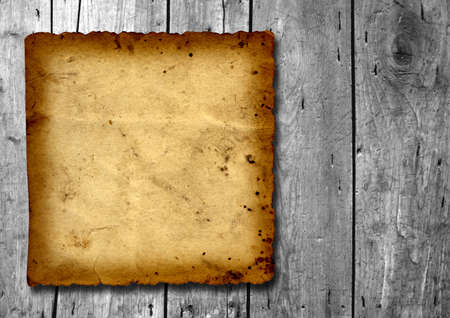 Vintage old grungy paper banner over an ancient wood texture backgroundの写真素材