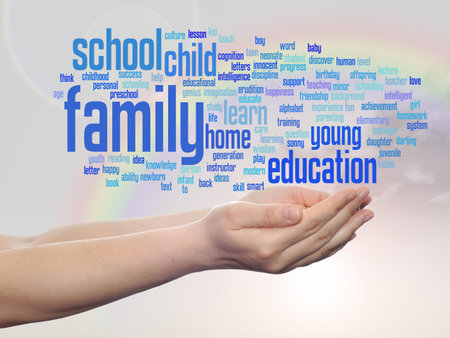 Conceptual education word cloud in hands over rainbow sky backgroundの写真素材