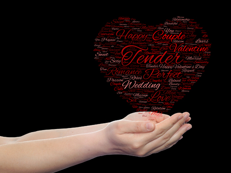 Conceptual love or Valentine heart shape word cloud isoalted on black held in human handsの写真素材