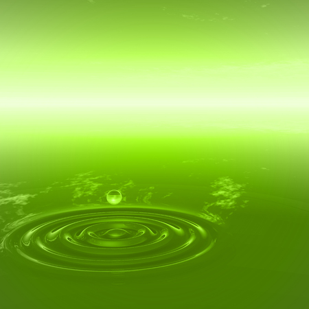 Conceptual green liquid drop falling in water with ripples and waves backgroundの写真素材