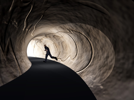 Conceptual 3D business man, dark road tunnel with bright light at the end backgroundの写真素材