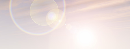 A sunset or sunrise background with clouds and the sun close to horizon bannerの写真素材