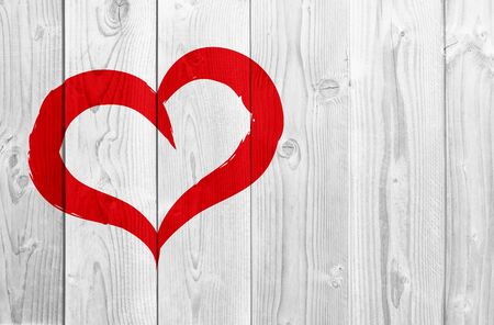 Conceptual painted red abstract heart shape love symbol made by happy child at school, old vintage wood backgroundの写真素材