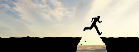 Conceptual business man silhouette jumping at sunset sky background bannerの写真素材