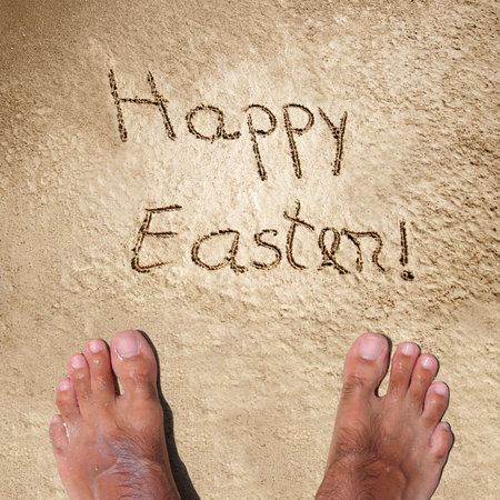 Concept or conceptual hand made or handwritten Happy Easter text in sand on a beach in an exotic islandの写真素材