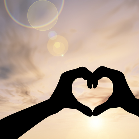 Conceptual heart shape sunset silhouette backgroundの写真素材