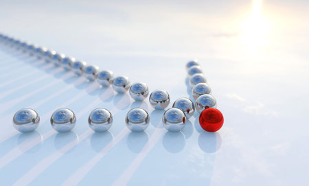 Concept or conceptual row of balls in form of an arrow with a red one standing out on blue...