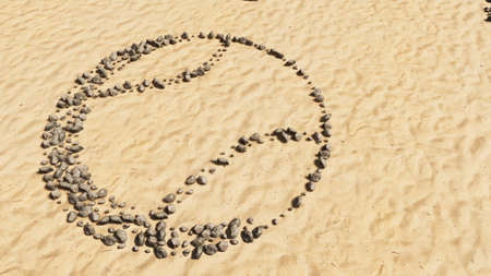 Concept conceptual stones on beach sand handmade symbol shape, golden sandy background, ball sign. A 3d illustration metaphor for sport, tennis, competition and fun or healthの写真素材