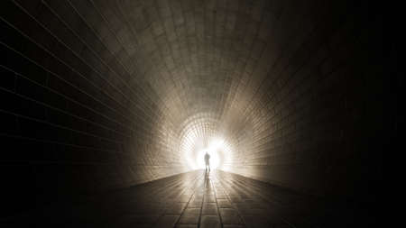 Concept or conceptual dark tunnel with a bright light at the end or exit as metaphor to success, faith, future or hope, a black silhouette of walking man to new opportunity or freedom 3d illustrationの写真素材