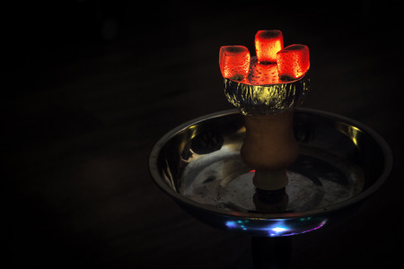 Hookah hot coals on shisha bowl with black background.の写真素材