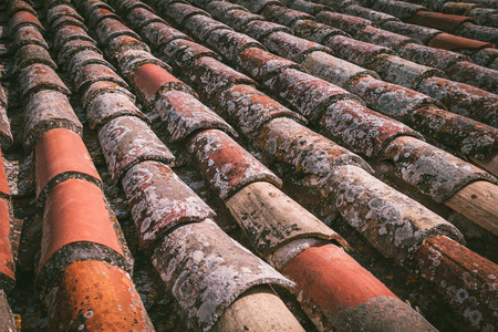 The old ancient shingles on the roof closeup. Tossa de Mar, Catalonia, Spain, Europe.の写真素材