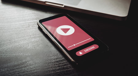 Boost video engagement with subscription reminders. Keep audience hooked with notifications and push reminders. Smartphone with subscribe bell button lying on wooden tableの写真素材