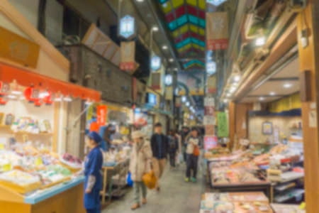 Blurred background. People shopping in Nishiki ichiba market. Nishiki ichiba market is a famous market in Kyoto, Japaの写真素材