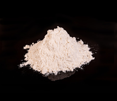 Drug powder close-up on a black background.の写真素材