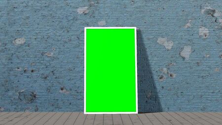 green screen frame in front of brick wall on wooden floor illuminated with spotlightの写真素材