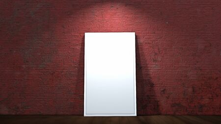 blank white frame in front of brick wall on wooden floor illuminated with spotlightの写真素材