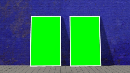 two green screen frames in front of brick wall on wooden floorの写真素材