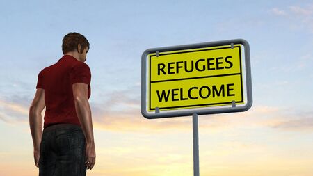 young man in front of Refugees Welcome Signの写真素材