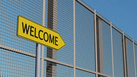 Welcome signpost on metal fence border fenceの写真素材