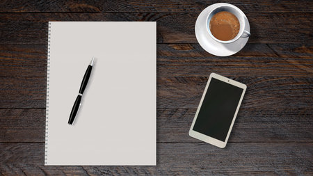 office table with smartphone coffee and white paper drawing padの写真素材