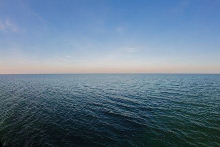 smooth sea with clear blue sky background at the baltic coastの写真素材
