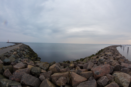 breakwater at the harbor entrance Rostock Warnemuende with view of the Baltic Seaの写真素材